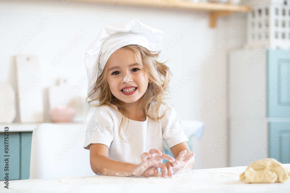 cute girl playing with dough for cookies on kitchen cute girl playing with dough for cookies on kitchen