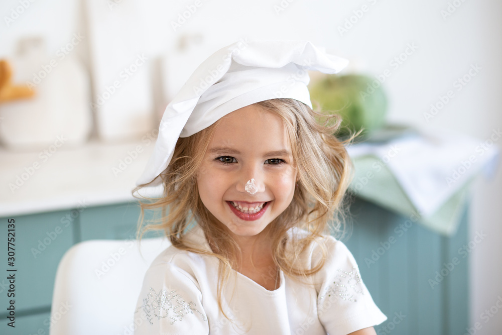 Cute little girl in the cook chef costume Cute little girl in the cook chef costume
