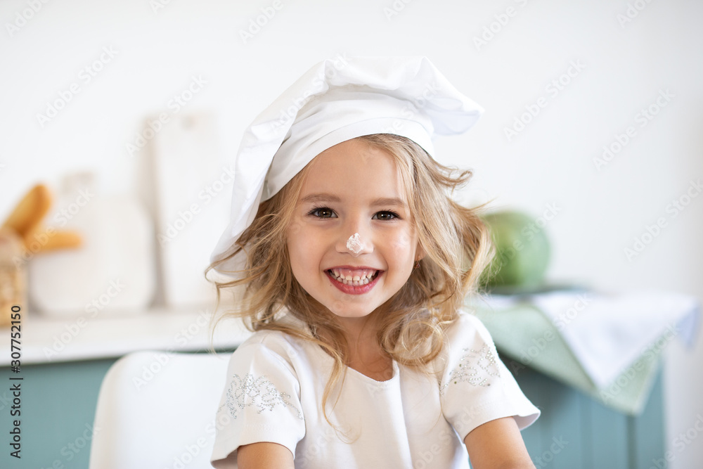Cute little girl in the cook costume Cute little girl in the cook costume