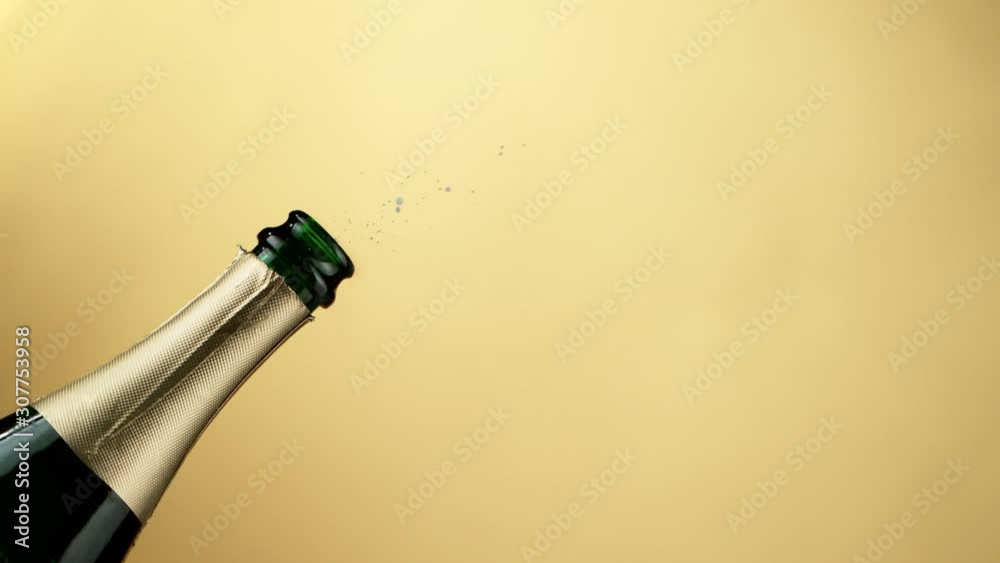 Super slow motion of Champagne explosion, opening champagne bottle closeup. Filmed on high speed cinema camera, 1000fps