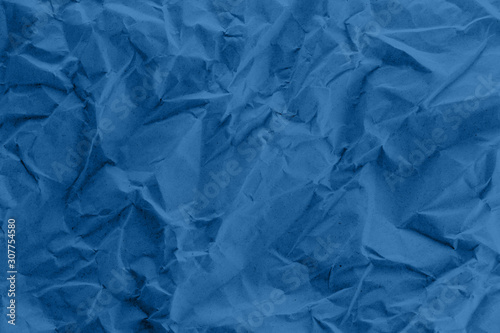A blue crumpled paper texture.