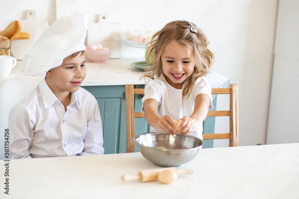 kids in white chef uniform preparing food on the kitchen kids in white chef uniform preparing food on the kitchen