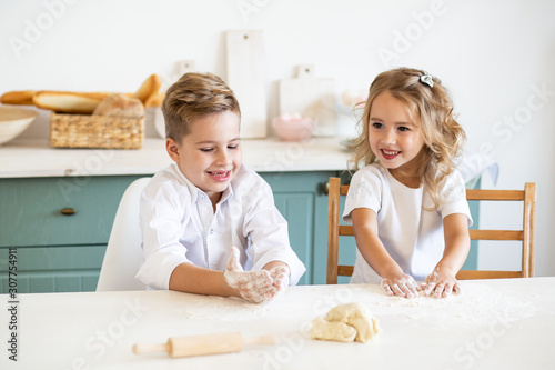 cute children playing in the kitchen at home