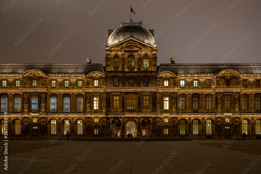 Paris, France - December 5, 2019: The famous square courtyard building of the Louvre Museum at night