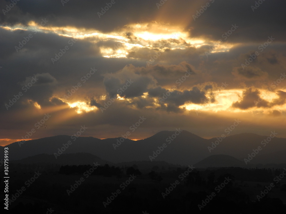 Sunset with beams of light over the mountains in Far North Queensland, Australia