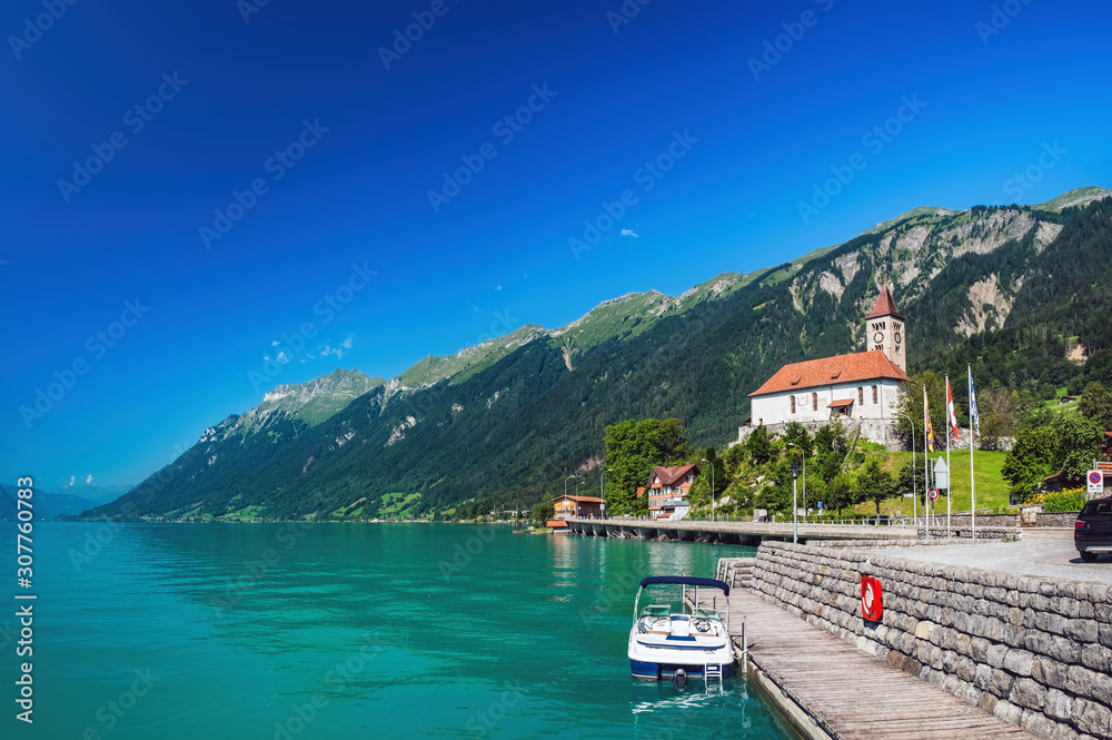 Panoramic view on the Brienz town on lake Brienz by Interlaken, Switzerland. Evangelical Reformed Church on the background