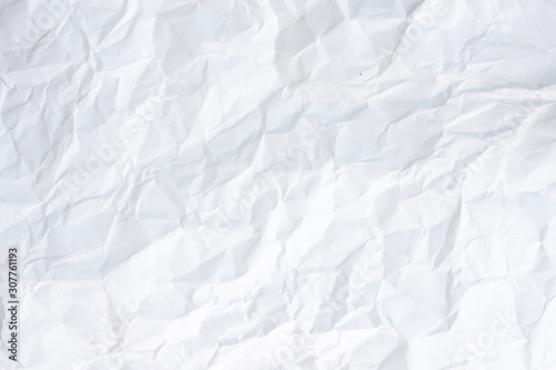 white and gray crumpled paper texture background. crush paper so that it becomes creased and wrinkled.