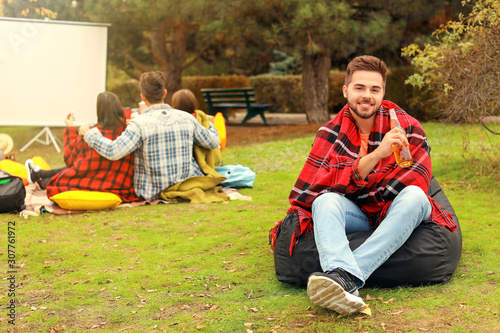 Happy young man with bottle...