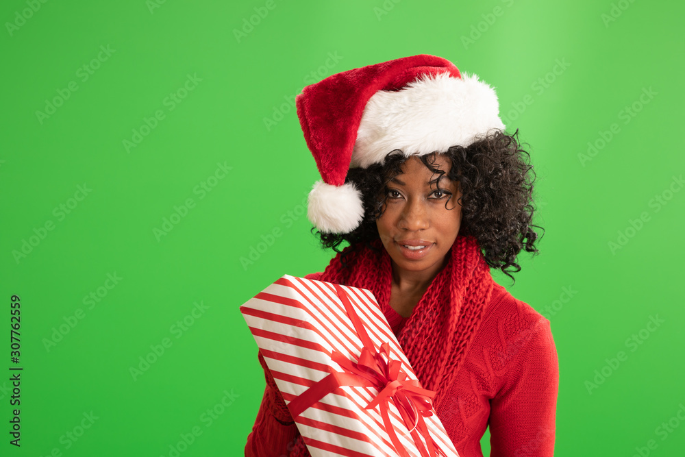 Beautiful happy African American woman holding Christmas gift in her arms Beautiful happy African American woman holding Christmas gift in her arms