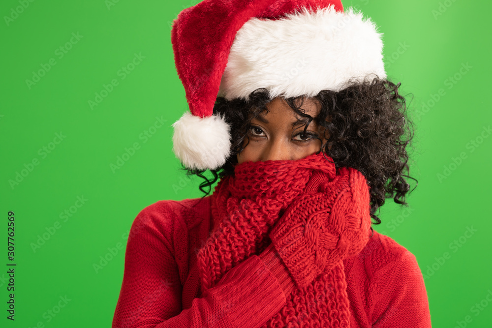 Portrait of playful woman in Christmas attire hiding behind her scarf Portrait of playful woman in Christmas attire hiding behind her scarf