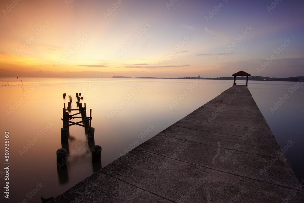 Long exposure shot of seascape with dusk sky background.