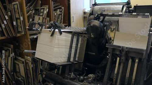 Printed sheets of paper are served in the printing press