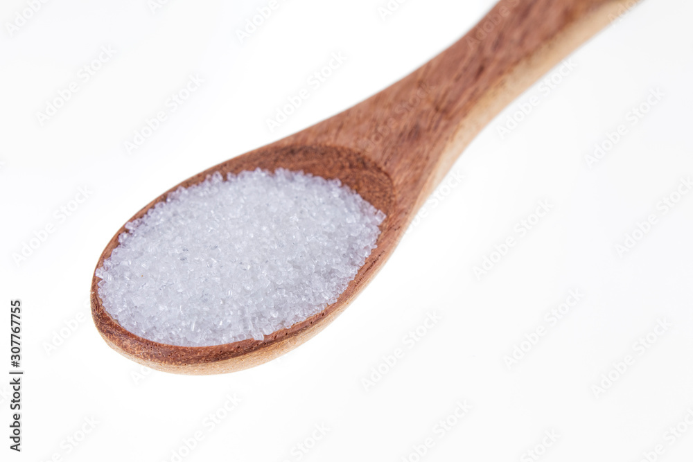 Spoon full of granulated sugar on a white background Spoon full of granulated sugar on a white background
