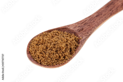 Spoon full of light brown sugar on a white background
