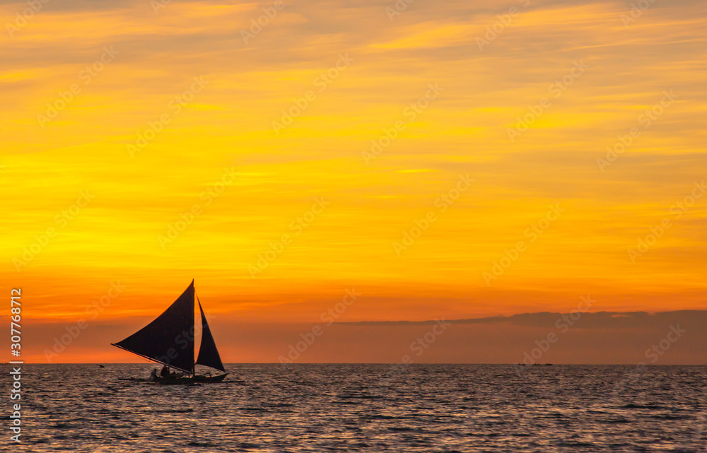 sailing boat at sunset. orange sky. boat on a sunset background. sailboat on a sunset background. beautiful sunset. unusual sky