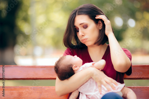Stressed Anxious Mother Holding Newborn Daughter 