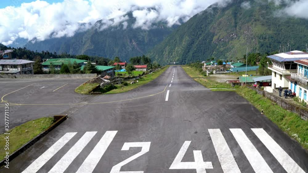 4K UHD Footage of twin-engine short-range plane landing at the runway of world's most dangerous airport in Lukla,Nepal. Tenzing–Hillary Airport at altitude 2,845 m