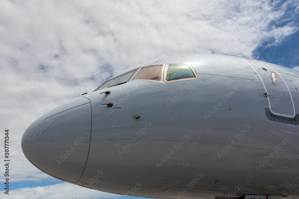 The nose of a plane against the sky