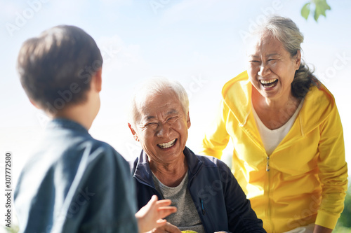 Photography asian grandparents and grandson enjoying nature in park