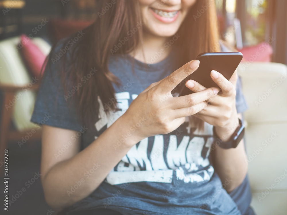 woman using smartphone in cafe on holiday woman using smartphone in cafe on holiday