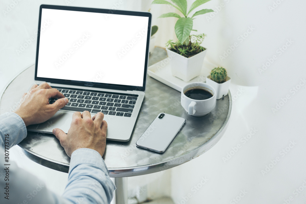 mockup image blank screen computer with blank white background for advertising text,hand man using laptop contact business search information on desk at home office.marketing and creative design mockup image blank screen computer with blank white background for advertising text,hand man using laptop contact business search information on desk at home office.marketing and creative design
