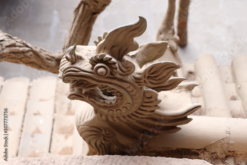 Architectural details of the roof at Tianshui Wushan Water Curtain Caves, Gansu China. OR Temple roof details at the Water Curtain Caves in Wushan , Gansu, China. photo