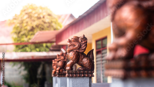 a bronze lion statue in a konghucu temple as a guard symbol