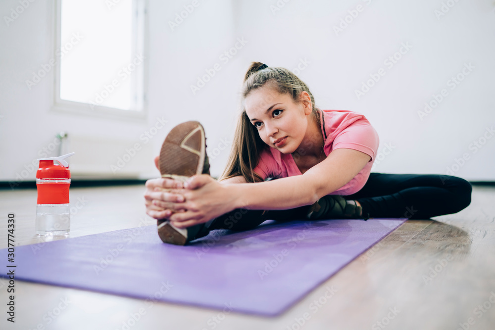 Shapely female training on yoga mat Shapely female training on yoga mat