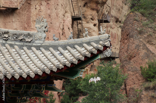 Architectural details of the roof at Tianshui Wushan Water Curtain Caves, Gansu China. OR Temple roof details at the Water Curtain Caves in Wushan , Gansu, China. photo