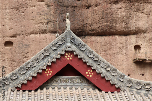 Architectural details of the roof at Tianshui Wushan Water Curtain Caves, Gansu China. OR Temple roof details at the Water Curtain Caves in Wushan , Gansu, China. photo