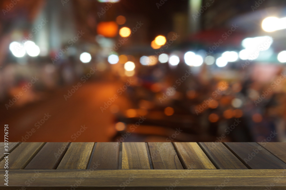 Empty dark wooden table in front of abstract blurred bokeh background of restaurant . can be used for display or montage your products.Mock up for space.