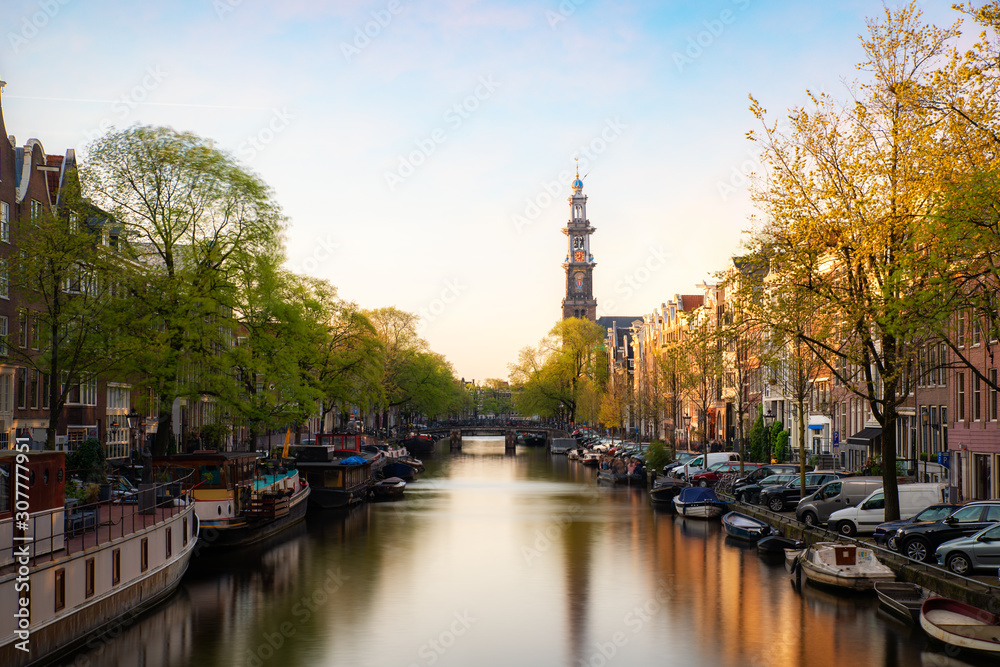 Canals of Amsterdam during sunset in Netherlands. Amsterdam is the capital and most populous city of the Netherlands. Landscape and culture travel, or historical building and sightseeing concept.