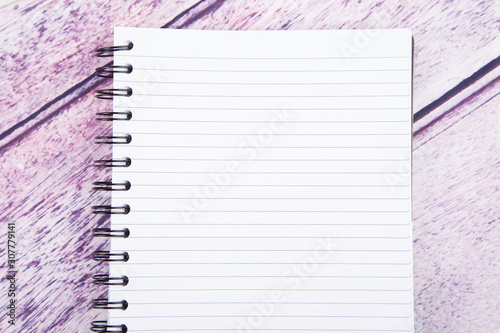 white note pad on purple wood desk 