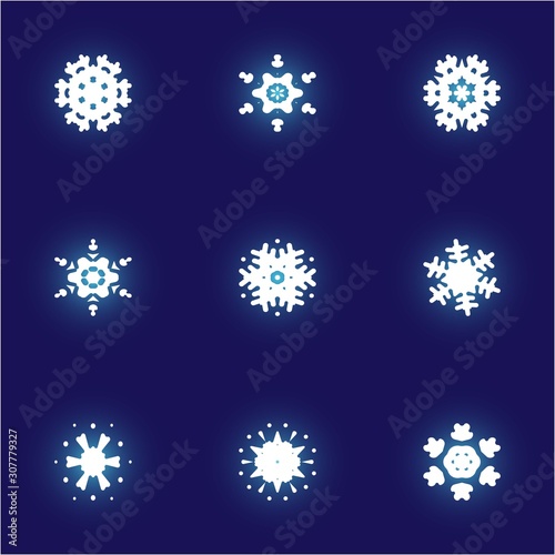 Set of isolated falling snowflakes on blue background.