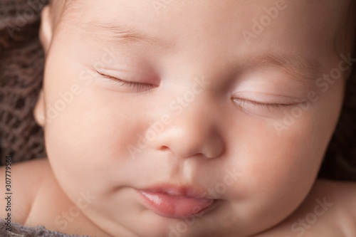 Sleeping newborn baby boy face 