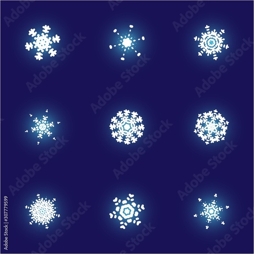Set of isolated falling snowflakes on blue background.