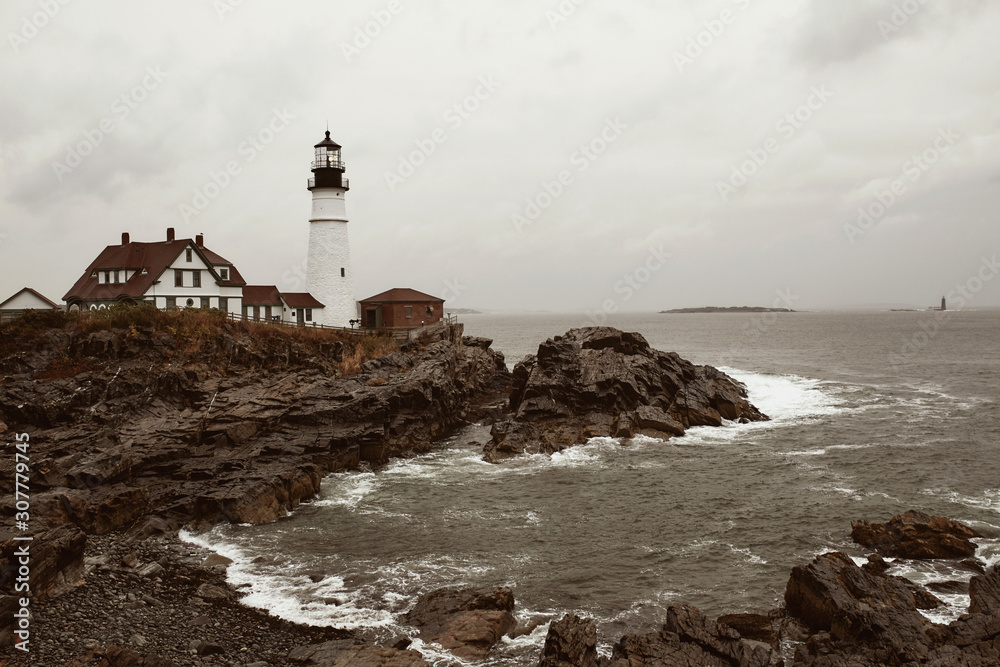 Portland Head Lighthouse on a cold and stormy Fall day in Cape Elizabeth, Maine, USA.