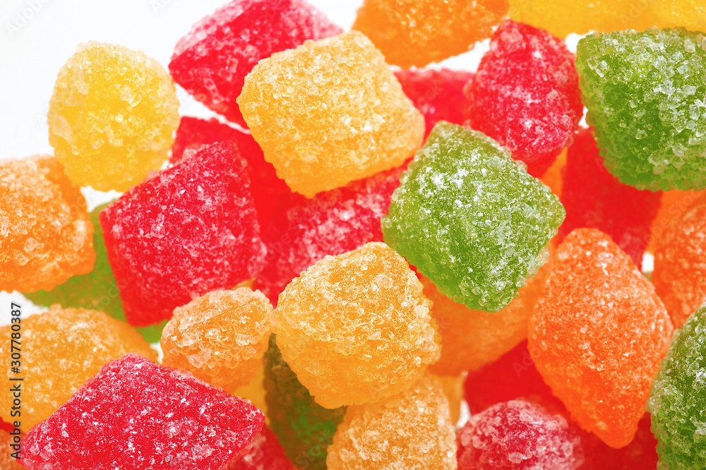 Children sweets: multi-colored lollipops on a white background. Bright colors: red, green, yellow, orange. Holidays: Christmas and New Year. Top view close up. Macro Children sweets: multi-colored lollipops on a white background. Bright colors: red, green, yellow, orange. Holidays: Christmas and New Year. Top view close up. Macro