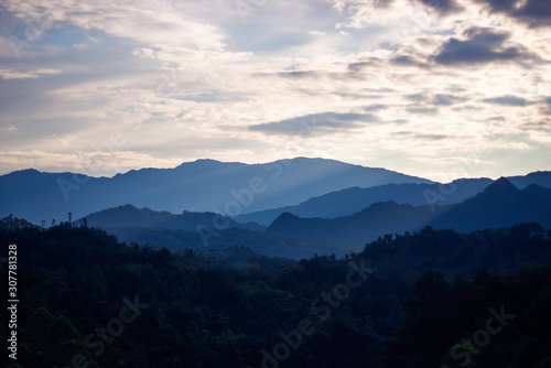 Beautiful mountains and forests with fog.At sunset.