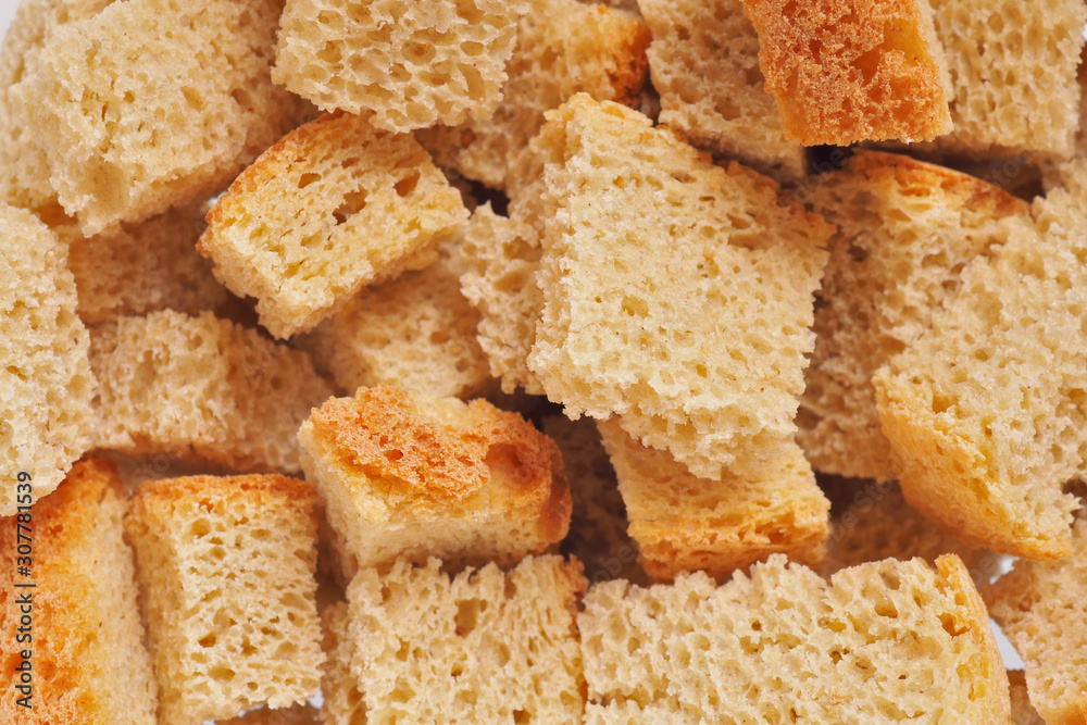 The surface of fresh homemade crackers. Light yellow warm background or wallpaper from food. View from above. Reduced contrast. Macro The surface of fresh homemade crackers. Light yellow warm background or wallpaper from food. View from above. Reduced contrast. Macro
