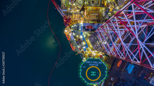 Aerial view offshore jack up rig  at night, Offshore oil rig drilling platform.