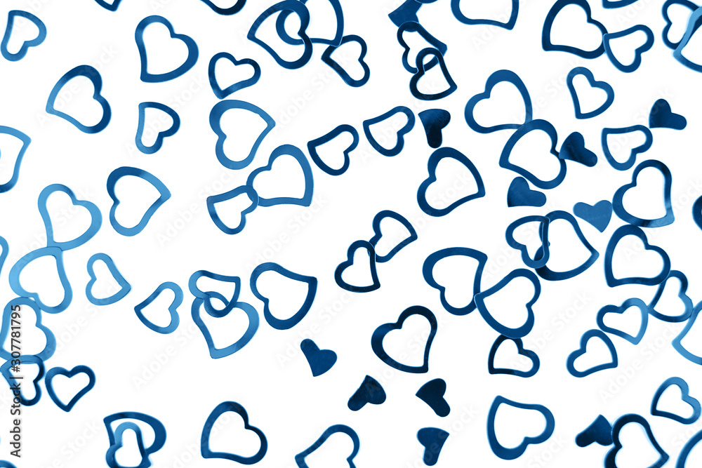 Valentines decoration of little blue confetti hearts on white background. Festive concept.