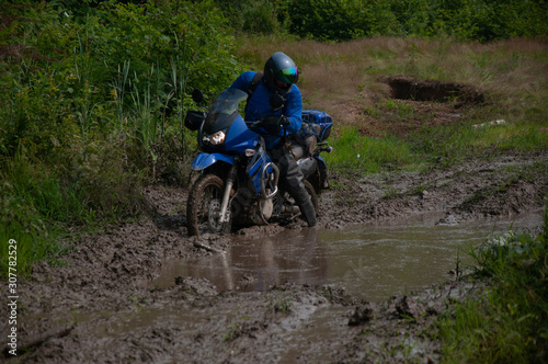Travelling on an enduro motorcycle in the taiga.