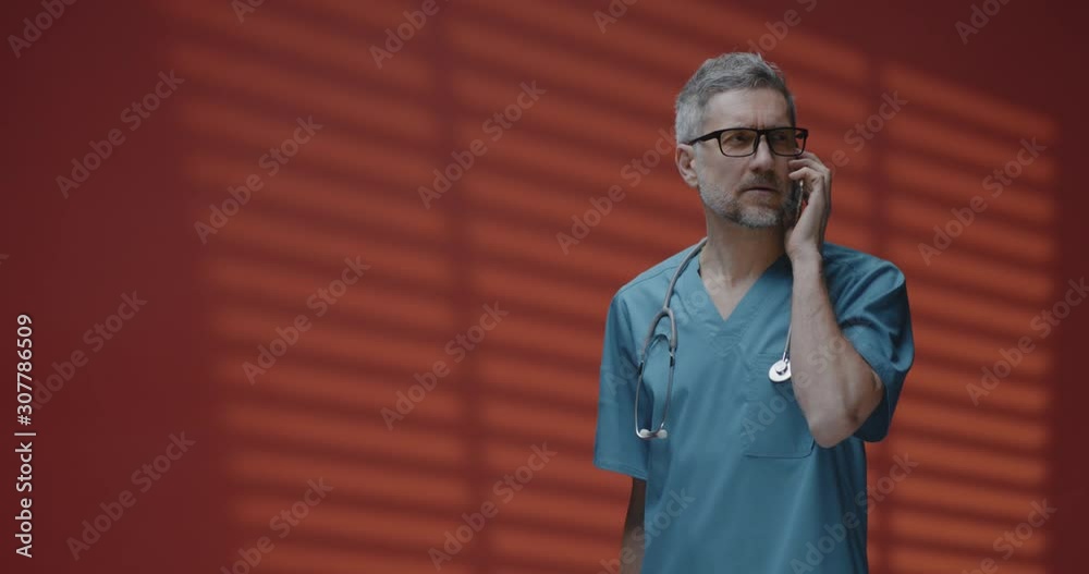 Male doctor having a phone call