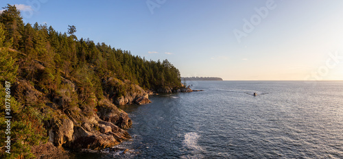 Panoramic View of Rocky Coast in Lighthouse Park, West Vancouver, British Columbia, Canada, with UBC in background. Taken during a cloudy sunset.