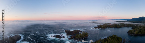 Ucluelet, Vancouver Island, British Columbia, Canada. Aerial Panoramic View of a Small Town near Tofino on a Rocky Pacific Ocean Coast during a cloudy and colorful morning sunrise.