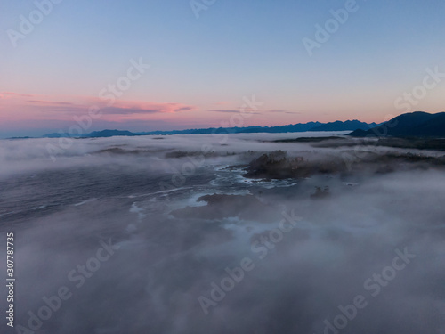 Ucluelet, Vancouver Island, British Columbia, Canada. Aerial Panoramic View of a Small Town near Tofino on a Rocky Pacific Ocean Coast during a cloudy and colorful morning sunrise.