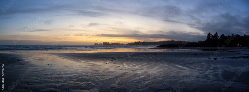 Long Beach, Near Tofino and Ucluelet in Vancouver Island, BC, Canada. Beautiful Panoramic view of a sandy beach on the Pacific Ocean Coast during a vibrant and colorful sunset.