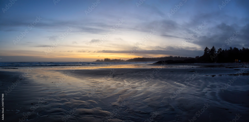 Long Beach, Near Tofino and Ucluelet in Vancouver Island, BC, Canada. Beautiful Panoramic view of a sandy beach on the Pacific Ocean Coast during a vibrant and colorful sunset.
