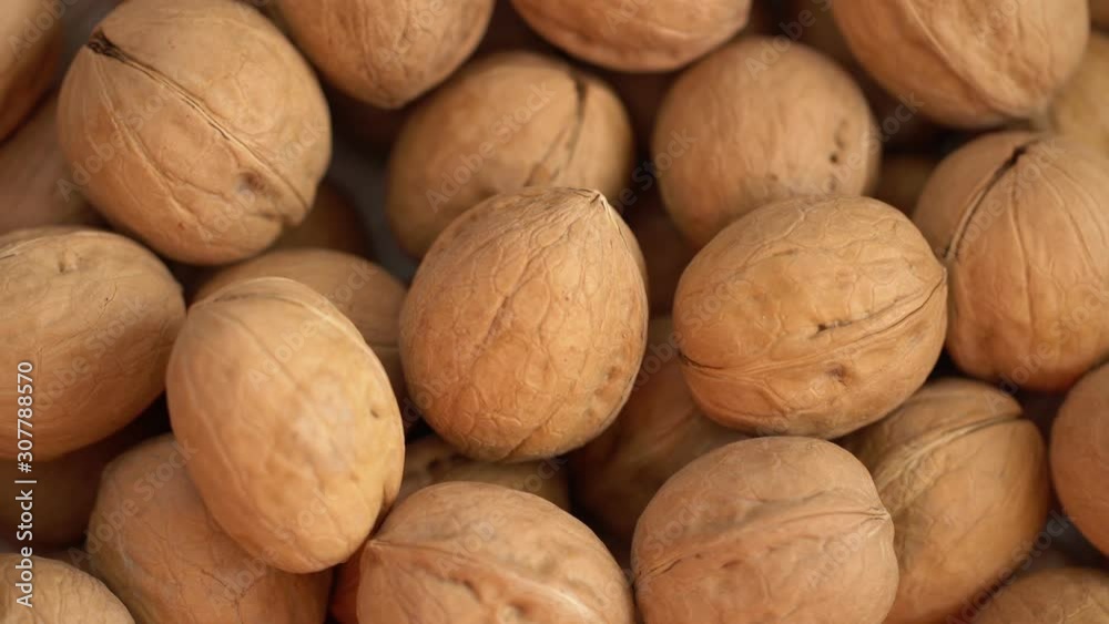 Walnut close up. product rich in minerals and vitamins. Walnut turns in a shot. Walnut kernels rotating. walnut close up lies under beams of the sun. Macro Walnut close up. product rich in minerals and vitamins. Walnut turns in a shot. Walnut kernels rotating. walnut close up lies under beams of the sun. Macro